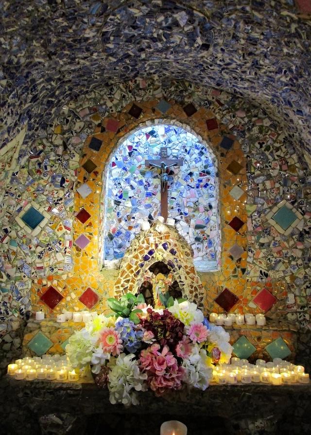 The chapel illuminated by sunlight, highlighting the intricate mosaics and stained glass windows