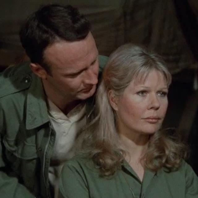 Margaret Houlihan is comforted by Hawkeye after an emotional breakdown in one of the more poignant scenes from M*A*S*H, showcasing her vulnerability amidst the pressures of war.