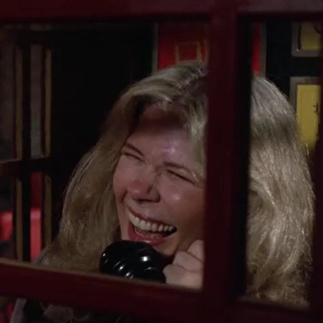 Margaret bursts into laughter during a phone call, offering a rare moment of levity amidst the backdrop of war