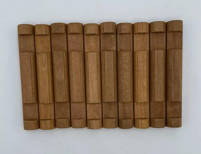 Rows of Lincoln Logs arranged for assembly, evoking memories of simple yet creative childhood play