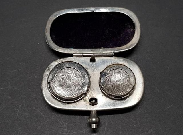 An antique coin holder with a rich patina, highlighting its age and the stories it could tell from its years of use.