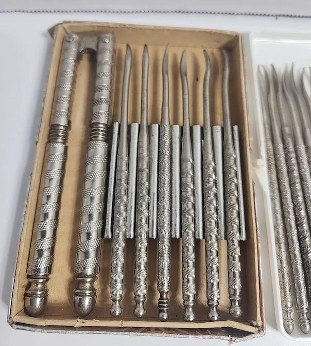 Detailed view of the handle and cracker tools from the vintage nutcracker silver stainless set, demonstrating the delicate engravings and design