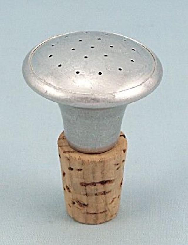 Simple in design but highly functional, this vintage sprinkler bottle top helped ensure clothes were ironed without creases