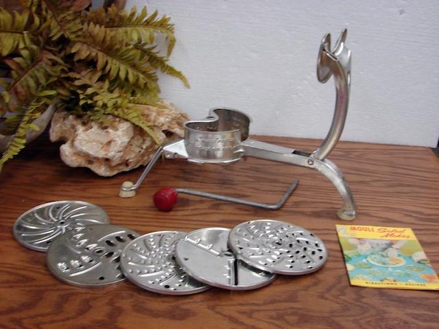 Displaying all the attachments, this Mouli grater could slice, shred, and grate with ease, showcasing the versatility of vintage kitchenware