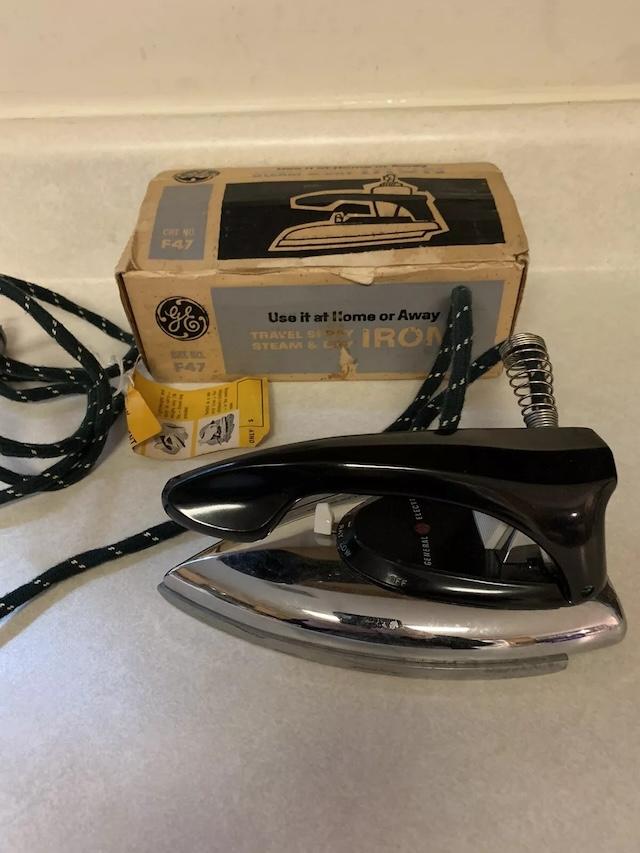 Packaged with care, this travel-sized GE steam iron made sure you looked your best on the go. Compact and powerful!