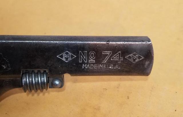 Close-up of the No. 74 marking on a vintage adjustable wrench. A small tool with a big role in history, proving its durability and design