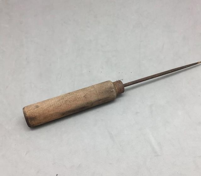 Sturdy and timeless. This vintage awl with a wooden handle has seen countless projects, each puncture marking its legacy