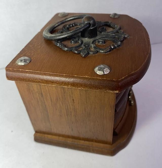 Side perspective of the wooden coaster box, highlighting the robust construction and thoughtful detailing that defined this era of design