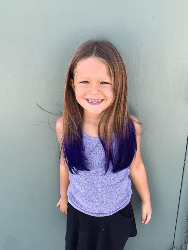 A pop of purple adds excitement to her look, but it’s a reminder to balance creativity with safety when it comes to kids