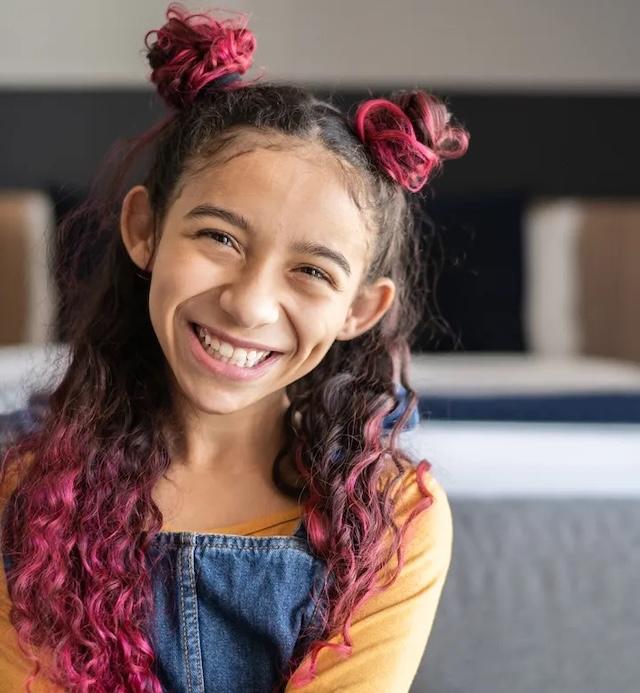 Bright smiles and pink highlights—an example of how kids love experimenting. But is there a better, safer way for them to express themselves?