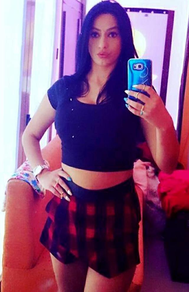 Enki strikes a pose in a fun, playful selfie, showing off her style with a cropped top and skirt. Her confident demeanor both on and off-screen has made her a known name in Albanian media