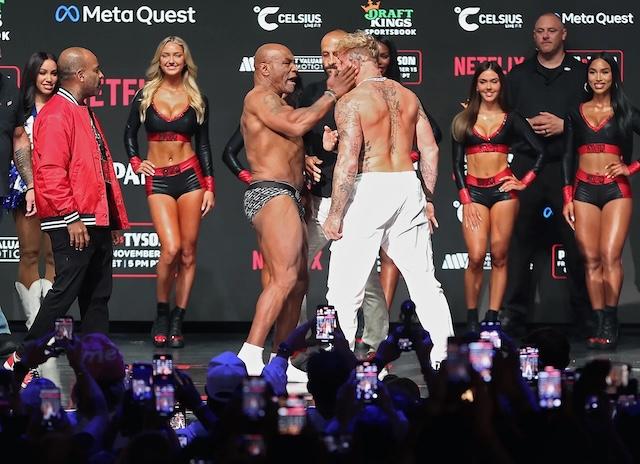 A moment from the face-off between Tyson and Paul, with Sydney Thomas in the background, stealing the spotlight during the weigh-in