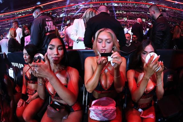 Sydney Thomas and fellow ring girls take a quiet moment before the fight begins, getting ready for their turn in the spotlight