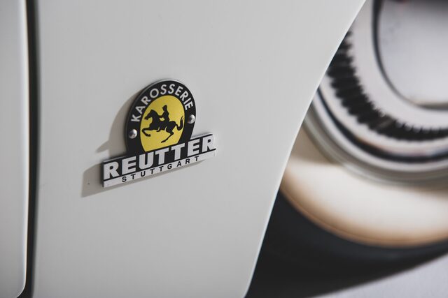 Close-up of the "Reutter" badge on the 1953 Porsche 356 Limousine, highlighting the craftsmanship and design by Reutter Karosserie of Stuttgart, Germany.