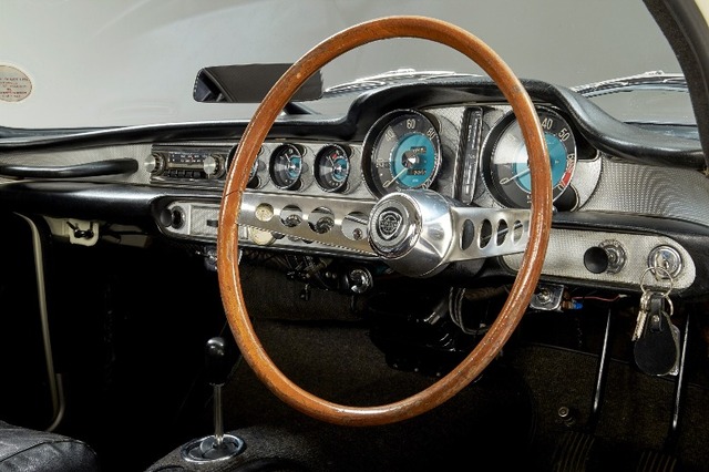 A detailed shot of the car's dashboard and vintage steering wheel, reflecting its elegant yet functional design that made it so beloved by fans and collectors.