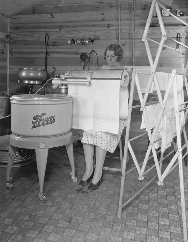 A farm woman using her electric mangle in Montgomery County, Indiana, 1930—a time-saving marvel for pressing clothes.