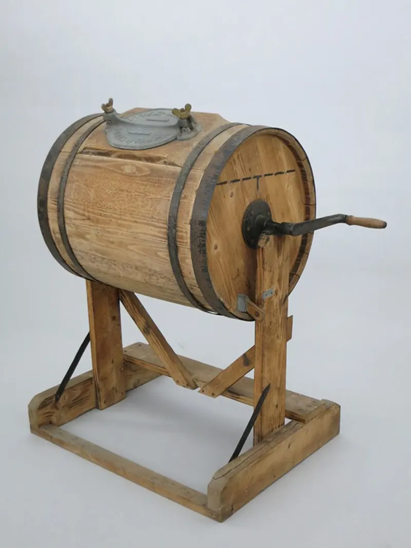 A manually operated, crank-powered washing machine—a glimpse into early laundry technology.