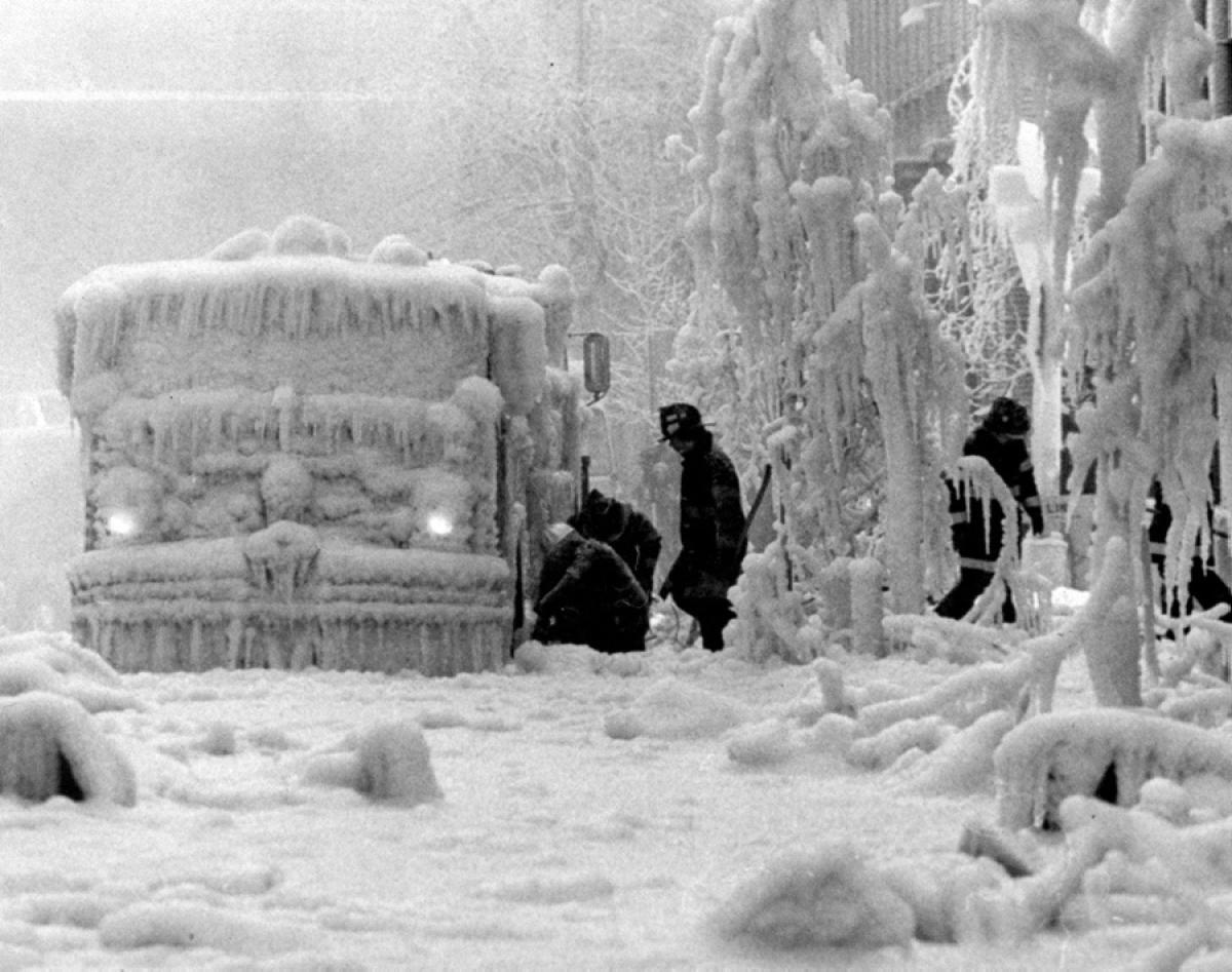 After battling a five-alarm fire in Brooklyn Heights, firefighters fight another enemy—equipment completely frozen in ice, 1980.