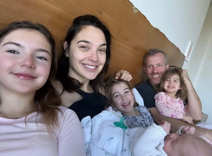 Gal Gadot and her family sharing a cozy and intimate moment together.