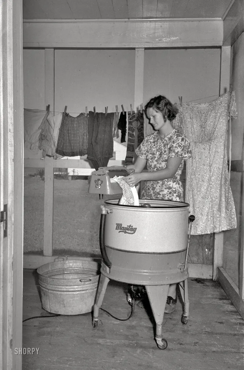 September 1938 – A farm wife washes clothes at the Lake Dick Project in Arkansas.