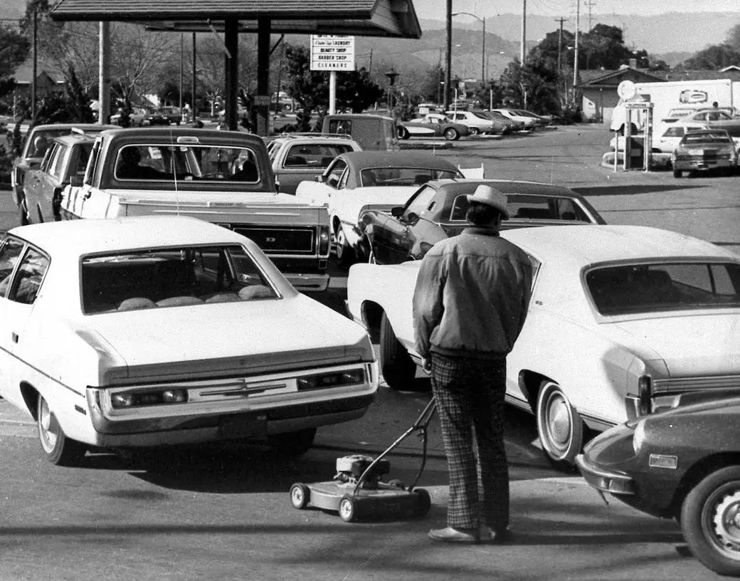 At this San Jose service station on March 15, 1974, it wasn’t just cars waiting—a man seeking a refill for his lawnmower joined the line, underscoring the era's widespread fuel scarcity