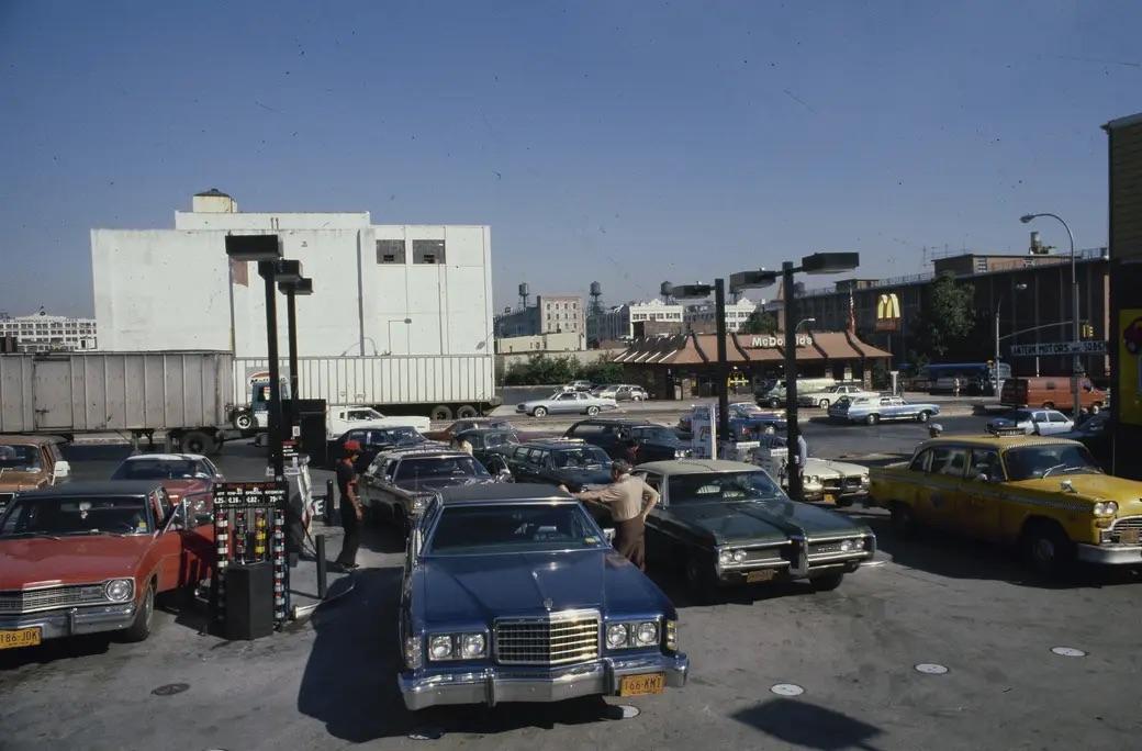 In 1979, New York's streets fill with cars as motorists patiently await their turn at the gas pumps—a vivid scene from the energy crisis