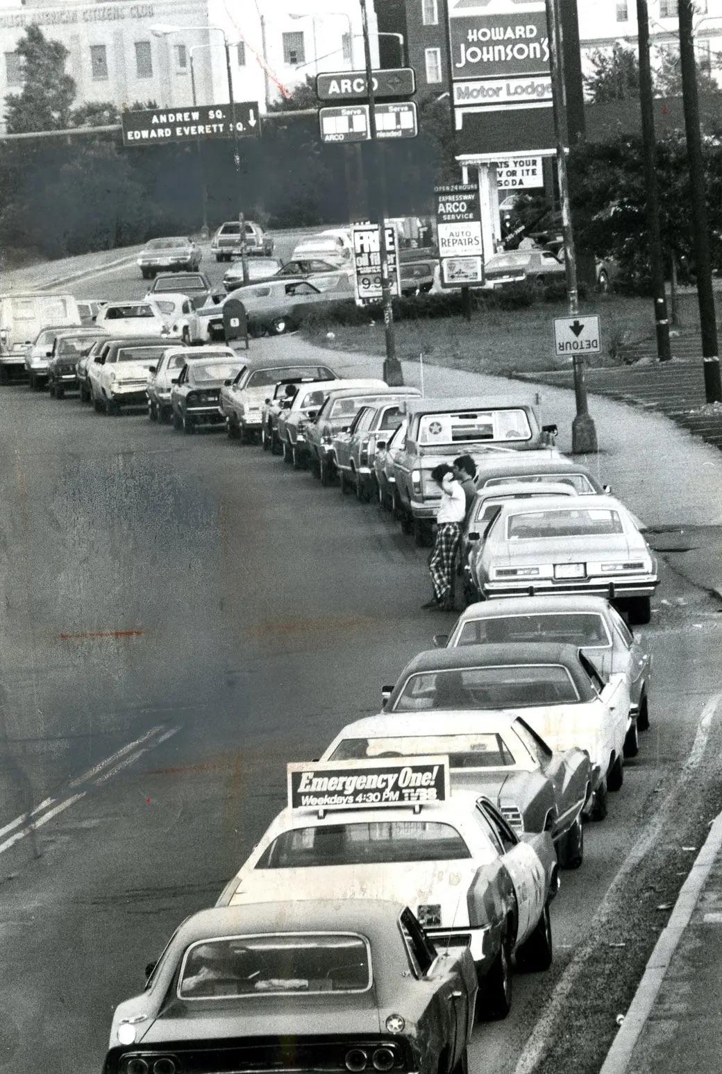 On June 15, 1979, cars from a long line along the Southeast Expressway outside an Arco station—a striking glimpse into the era's fuel shortages