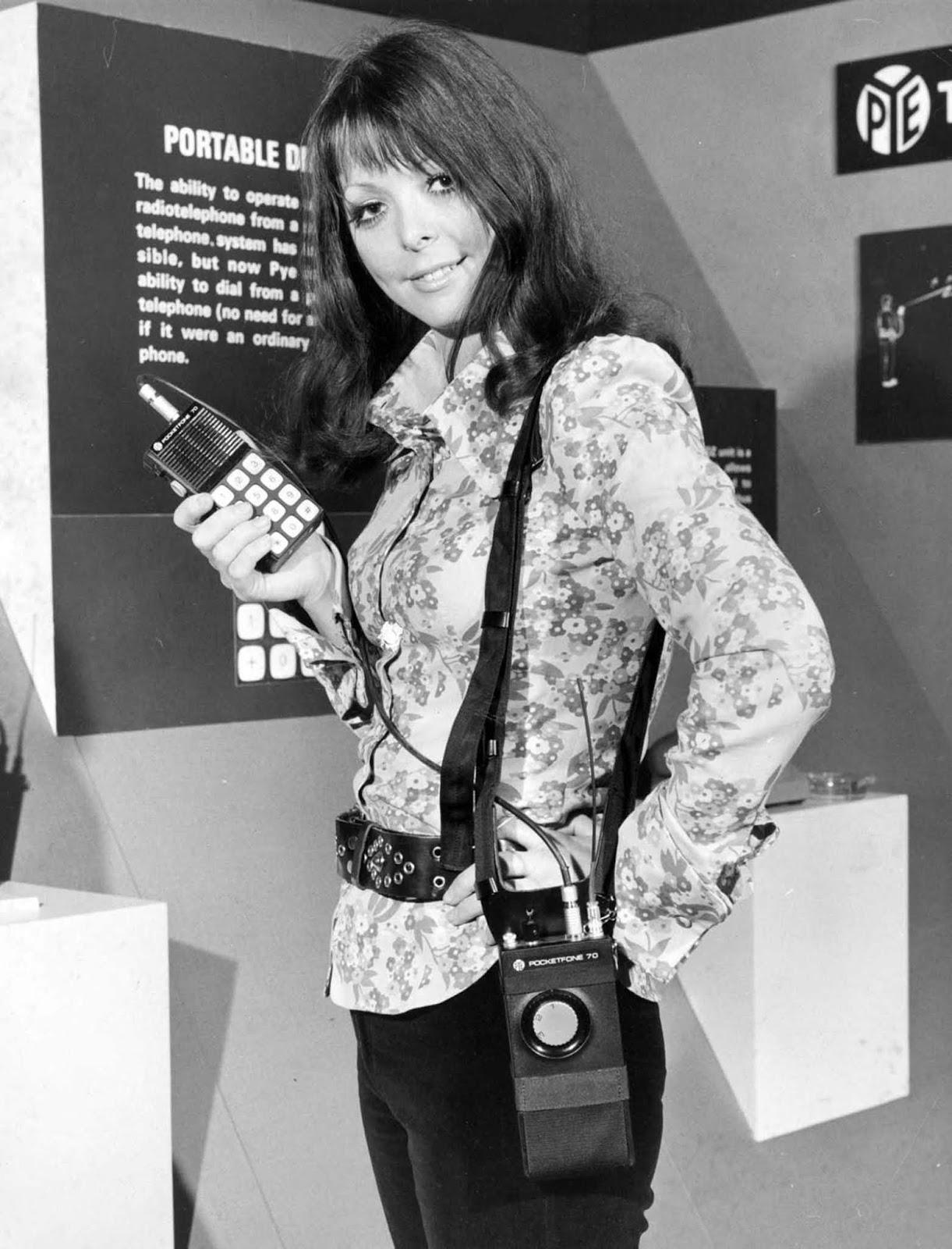 The portable radio-telephone, a precursor to the mobile phone, revolutionized communication by connecting directly to telephone systems. Here, a model showcases one of these early innovations at the “Communications Today, Tomorrow, and the Future” exhibition in London, 1973.
