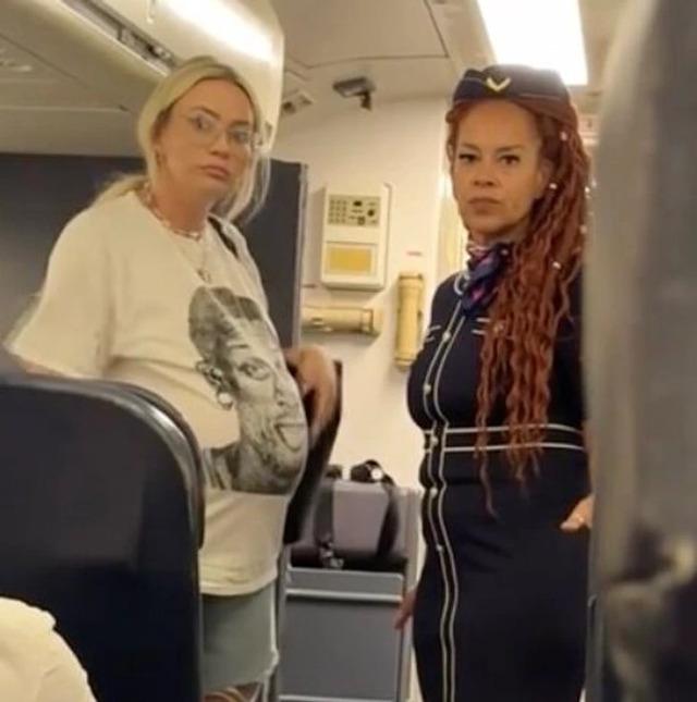 A fellow passenger recorded the tense moment when a pregnant woman tried to claim an empty first-class seat for free, sparking a heated exchange with the flight attendant.