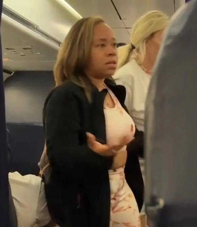 A first-class passenger, noticing the situation, steps in and generously offers their seat to the distressed pregnant woman, ending the standoff.
