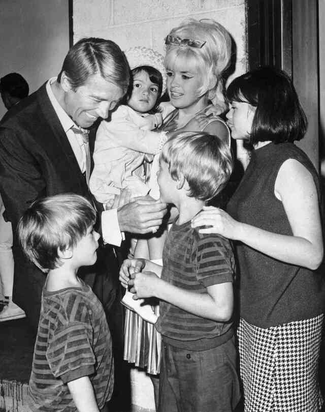 A heartfelt moment with Jayne Mansfield and Mickey Hargitay, surrounded by their children, showcasing the bond of family. BETTMANN/GETTY