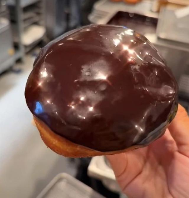 A perfectly glazed chocolate donut, a delicious creation from Lively’s special donut-making session at Rise Doughnuts.
