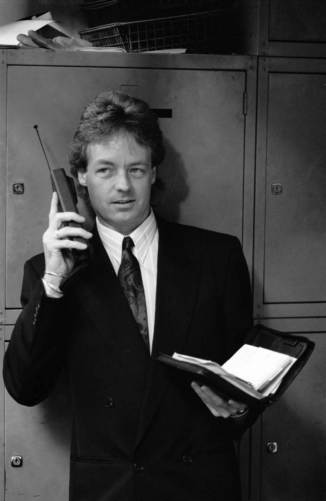A quintessential ’80s man, sporting the signature fashion of the era, from his oversized blazer to the ever-present mobile phone.