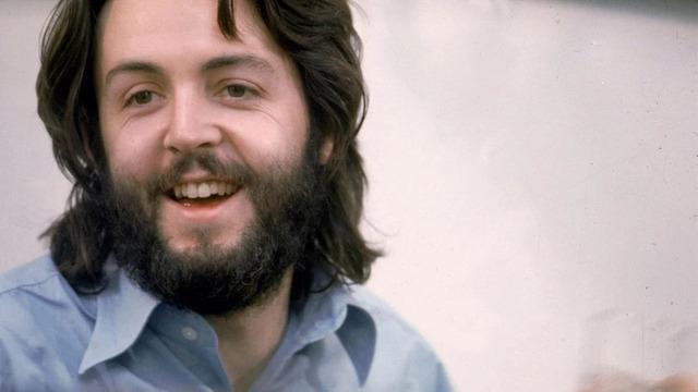 A relaxed and iconic image of Paul McCartney, exuding the carefree energy of The Beatles in the 1970s.
