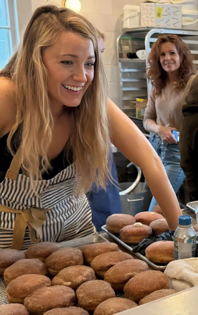 Blake Lively beams as she interacts with fans at Rise Doughnuts, sharing her passion for baking and enjoying the experience.
