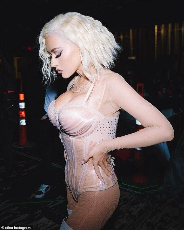 Christina Aguilera channels her iconic bold energy in a stunning nude corset and platinum blonde look, showcasing her timeless beauty and fierce style on stage.