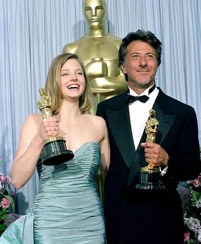 Iconic Oscar Moment – Jodie Foster and Dustin Hoffman smile with their Oscars at a star-studded event.
