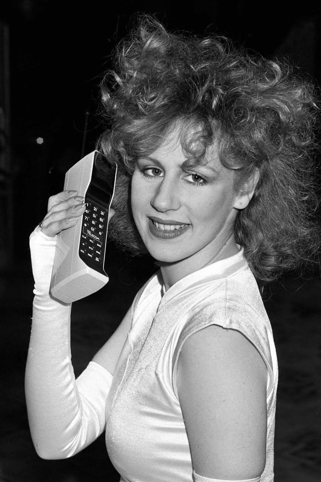 In 1985, a model proudly presents the mobile phone at the launch of the Cellnet cellular radio system in London, marking another milestone in mobile communication.