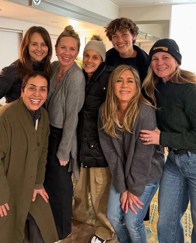 Jennifer Aniston with her friends, sharing a joyful moment together.