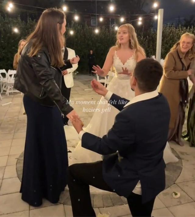 The newlyweds didn’t seem to mind the interruption, but the incident sparked widespread debate online about the ethics of proposals at weddings.