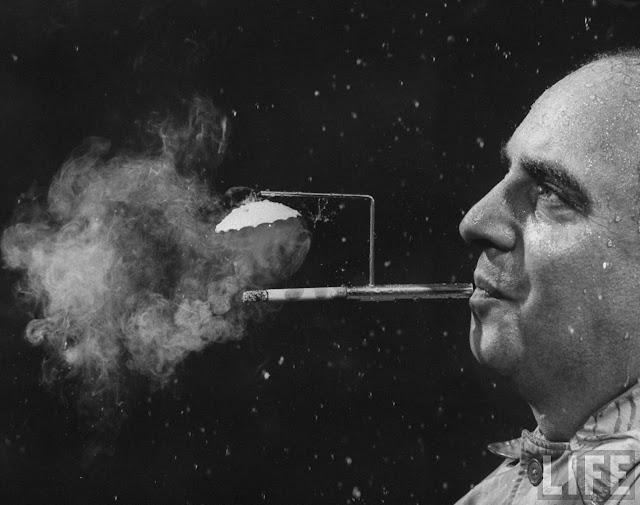 The umbrella holder for smokers on rainy days – ensuring your cigarettes stay dry no matter the weather. (Photo by Joel Yale/LIFE magazine).