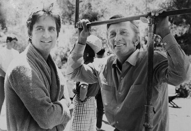 A behind-the-scenes moment with Kirk Douglas and his 24-year-old son Michael on the set of "Hail, Hero."