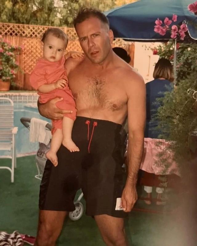 A father-daughter moment of pure joy – Bruce Willis and his young daughter share a sunny day by the pool.