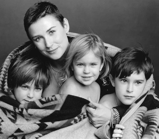 Demi Moore with her three children wrapped in love – a timeless family portrait.