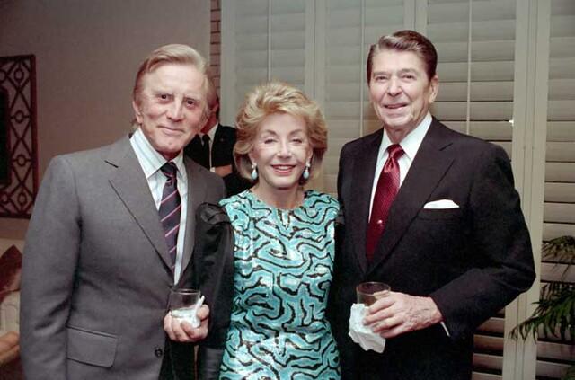 Kirk Douglas and wife Anne with President Ronald Reagan at an event in December 1987.