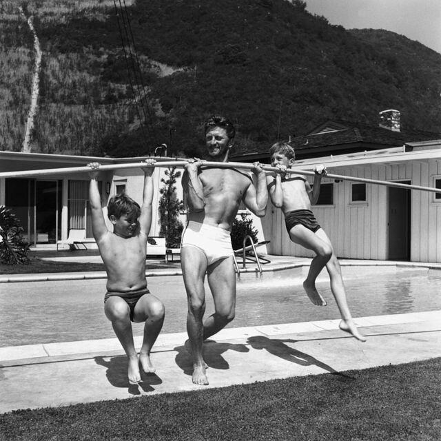 Kirk Douglas with his sons Joel and Michael (right) in 1955—capturing a precious family moment.