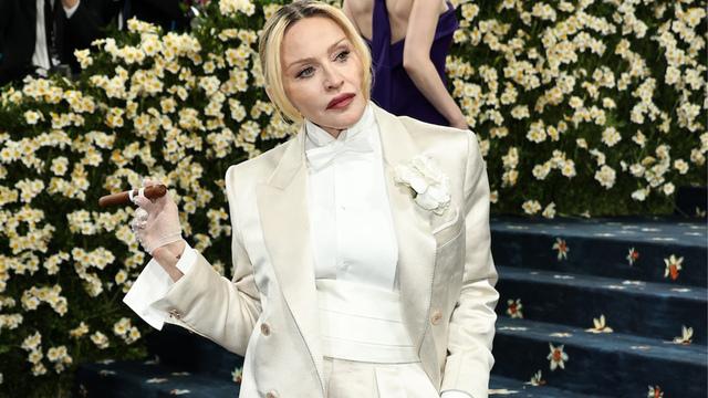 Madonna’s makeup was striking, featuring bold fuchsia lips and smoky eyes that added depth and drama.