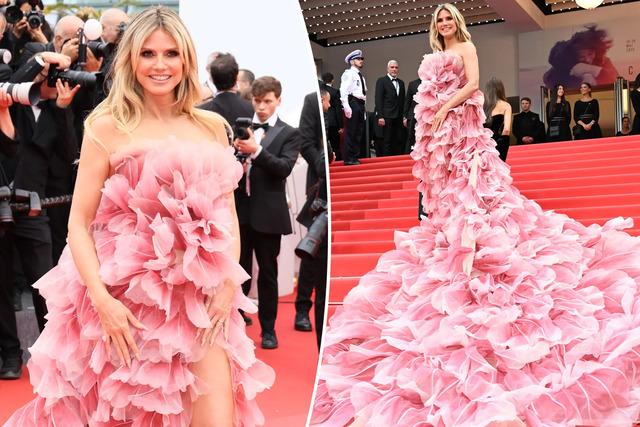 Heidi Klum graced the red carpet in a vibrant pink strapless Elie Saab gown with delicate petal details trailing a long floor-length train.