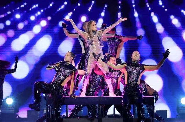Jennifer Lopez electrifies the stage during a dynamic performance, wearing a sparkling bodysuit with dancers.