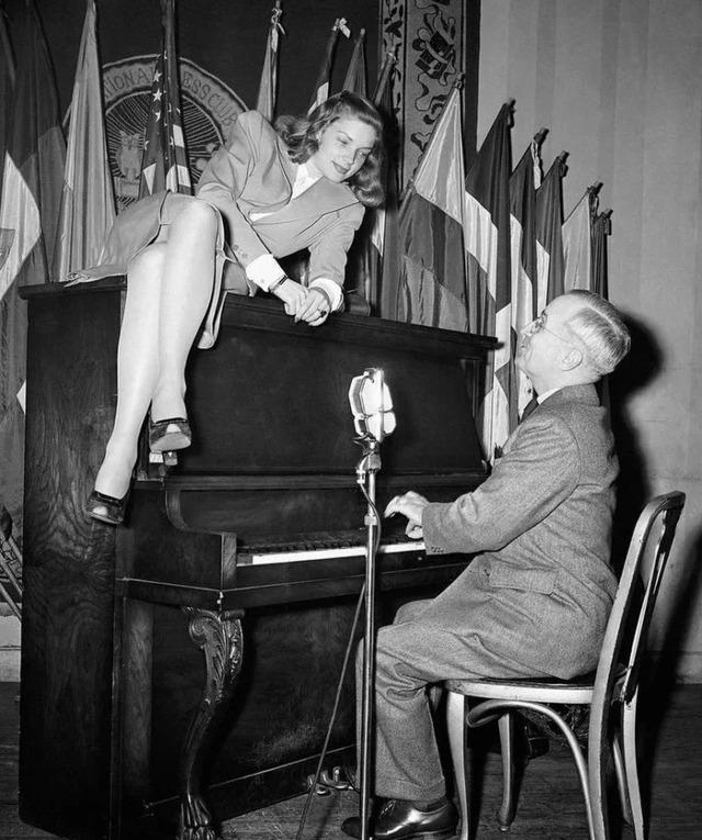 A radiant Bacall in a dramatic black-and-white portrait, her smoky eyes and poised expression epitomizing classic Hollywood allure.